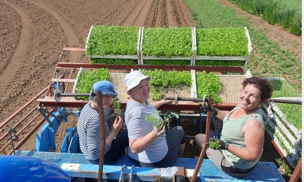 Sabine Rossnagl und Familienmitglieder sitzen auf einer landwirtschaftlichen Maschine